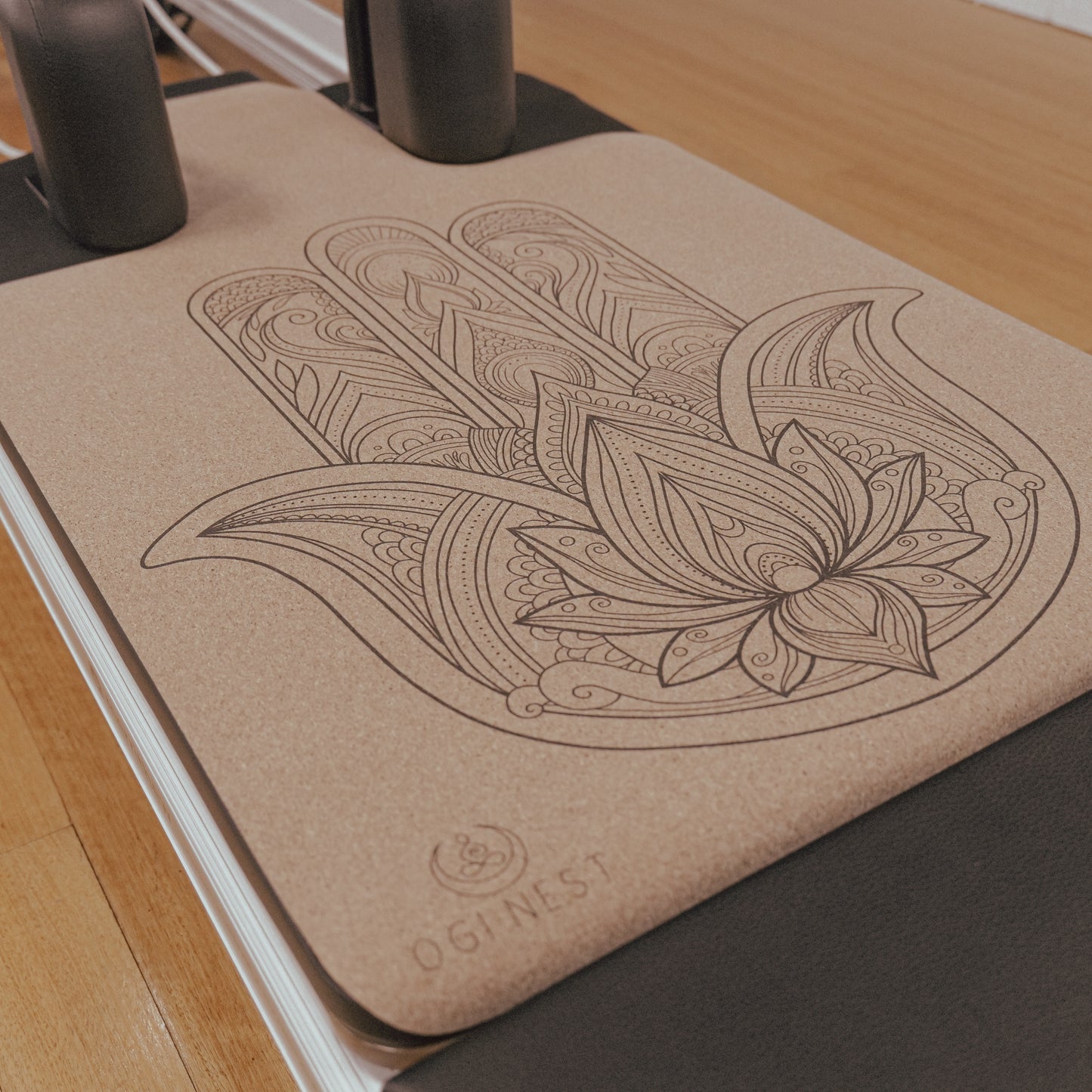 Hamsa hand cork and natural rubber Pilates reformer mat.